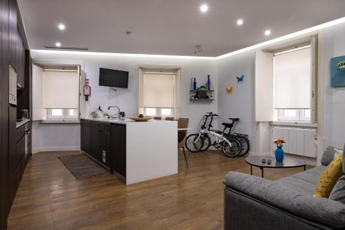 a living room with a couch and a kitchen at Casa da Ladeira by Trip2Portugal in Figueira da Foz