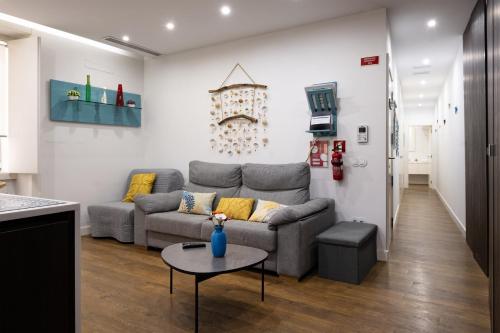 a living room with a couch and a table at Casa da Ladeira by Trip2Portugal in Figueira da Foz