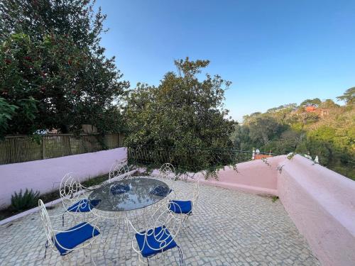 a patio with a table and chairs on a patio at Casa Didi - 3km do centro - by Trip2Portugal in Sintra