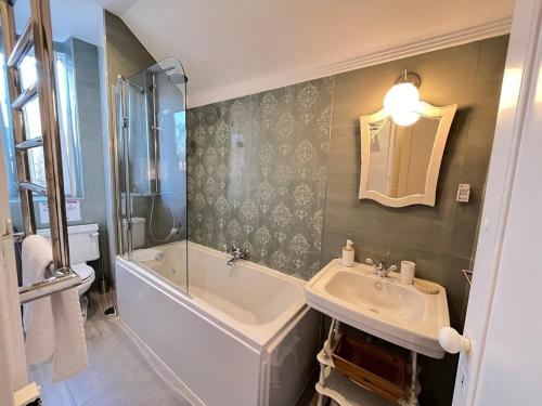 a bathroom with a sink and a tub and a shower at Casa Didi - 3km do centro - by Trip2Portugal in Sintra