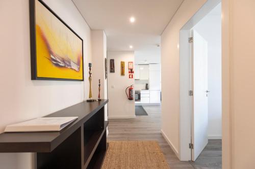 a living room with a desk and a hallway at Comfort & Style w/ best sea view in Sesimbra