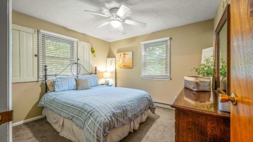 a bedroom with a bed and a ceiling fan at Double Diamond Lodge by AvantStay Group Escape w Firepit Patio Activities in Lake Harmony