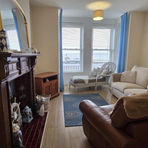 a living room with a couch and a fireplace at Ships Ahoy in Carrickfergus