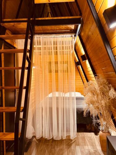 a bedroom with a bed in a attic at Orange Cottage in Agara