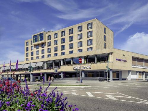 a large building with a sign on the front of it at Mercure Hotel Trier Porta Nigra in Trier