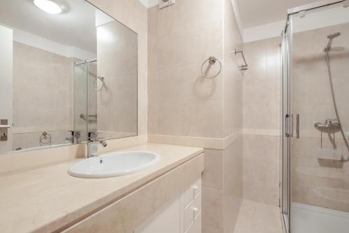 a white bathroom with a sink and a shower at Elegant Apartment with Sea Views by Trip2Portugal in Funchal