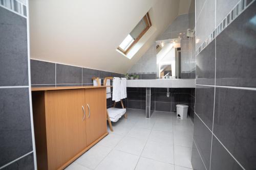 a bathroom with a sink and a toilet in it at Logis-Hôtel & Restaurant LE CARNOT in Bolbec