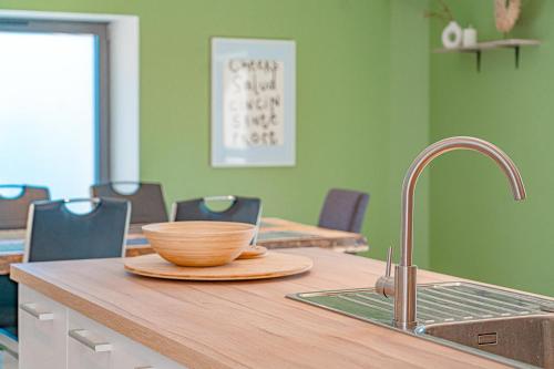 a bowl on a plate on top of a kitchen counter at Le gîte de la Bonne Amie in Coubon