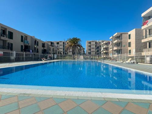 a large swimming pool in front of some buildings at Espectacular Y Amplio Las Américas in Playa de las Americas