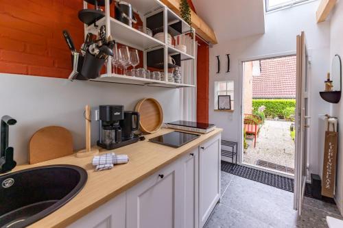 a kitchen with a sink and a counter top at Nordseenest in Krummhörn