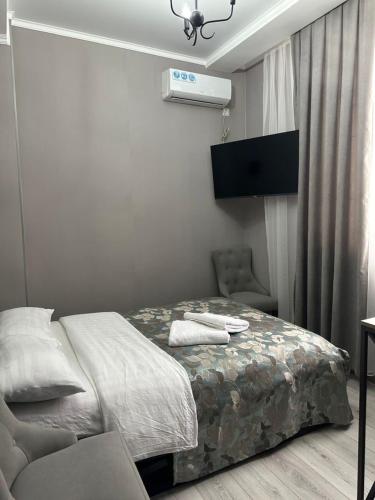 a bedroom with a bed and a chair in it at Охота in Bishkek
