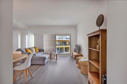 a living room with a couch and a table at Iva's Panoramic Sesimbra in Sesimbra