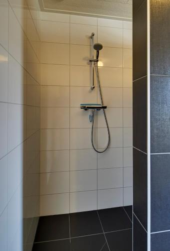 a bathroom with a shower with a shower head at Lokven Hoeve in Vinkel