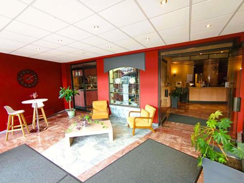 a lobby with chairs and a table in a building at Mercure Limoges Centre in Limoges