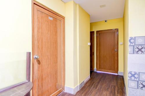a hallway with a wooden door in a room at Super Hotel O Three Sixty Five Inn Guest House in Salt Lake City