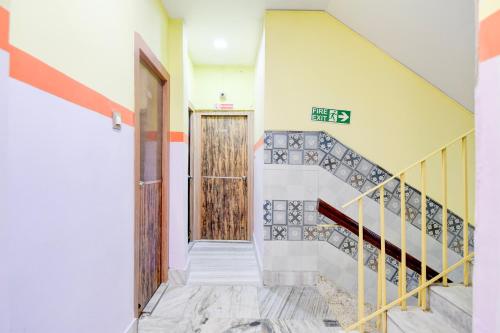 a hallway with stairs and a wooden door at Super Hotel O Three Sixty Five Inn Guest House in Salt Lake City