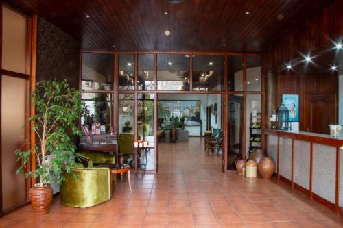 a lobby of a restaurant with plants in it at Pantanha Apartment 02 by Trip2Portugal in Nelas