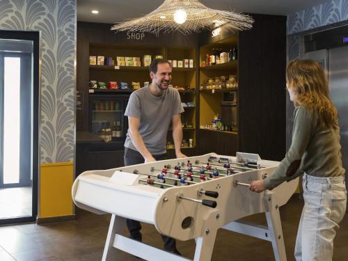 a man and a woman standing next to a giant chessboard at Aparthotel Adagio Annecy Centre in Annecy