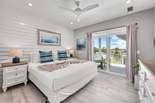 a bedroom with a bed and a balcony at Beach Fanta Sea - 149 in Bailey Hall