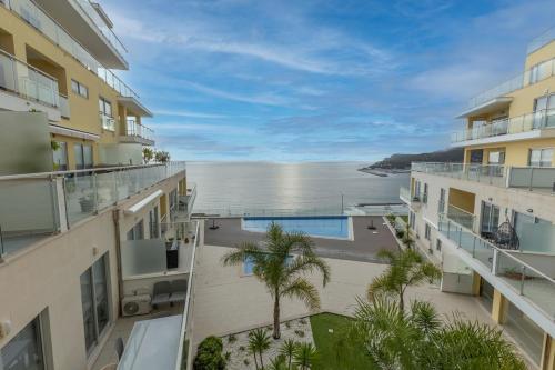 a view of the ocean from the balcony of a building at Sea Sound Apartment by Trip2Portugal in Sesimbra