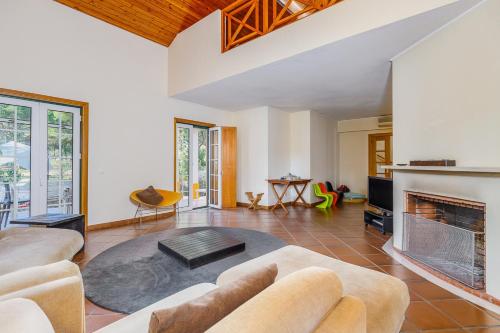 a living room with a couch and a fireplace at Villa 97 by Trip2Portugal in Alcácer do Sal