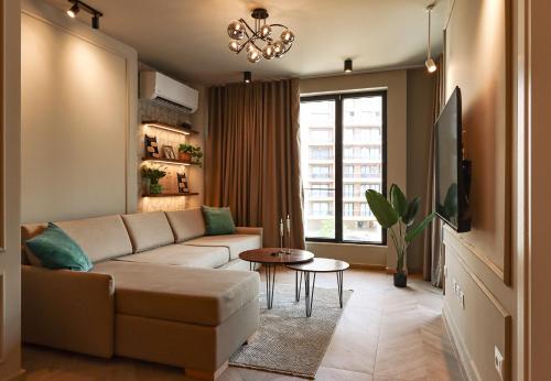a living room with a couch and a table at Azure Escape luxury apartments Sarande in Sarandë