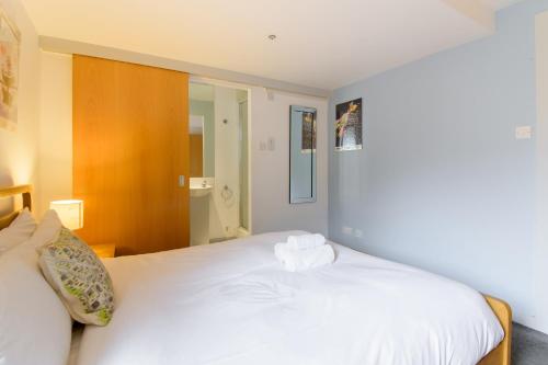 a bedroom with a large white bed in it at Modern Flat in the Middle of Old Town in Edinburgh