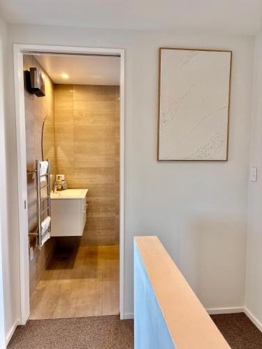 a bathroom with a sink and a mirror at Travellers' dream steps from shops and close to Airport in Christchurch