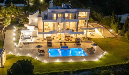 an aerial view of a house with a pool at night at Monte Smith Luxury Villas in Rhodes Town