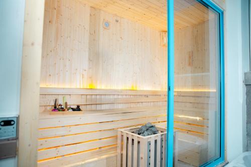 a sauna with wooden walls and a glass window at Ha Long 4BRS Beach Villa With Pool, Jacuzzi and Sauna in Ha Long