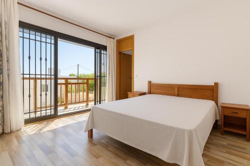 a bedroom with a white bed and a large window at Hope Villa in Calodyne