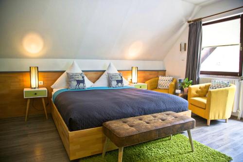 a bedroom with a large bed and a couch at Das Waldhaus - Winter Boardinghaus in Forbach