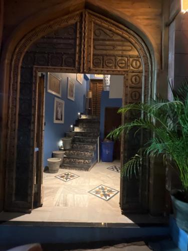 an archway leading into a room with stairs at Marwar Mosaic Heritage Haveli in Jodhpur