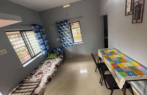 a room with two beds and a table and chairs at ROB'S INN Groupstay 