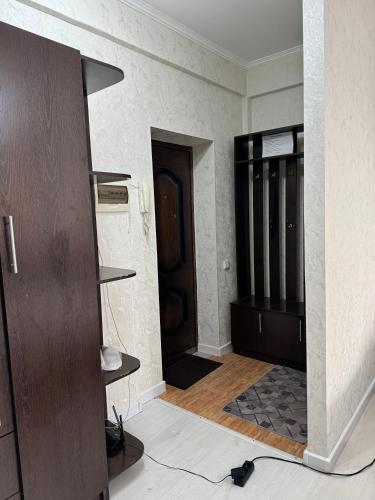 a room with a hallway with a door and a floor at Уютная Квартира Ай in Zhezdi