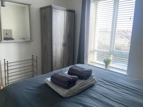a bedroom with two pillows on a bed with a window at Pennethorne Apartment in Clooney Park