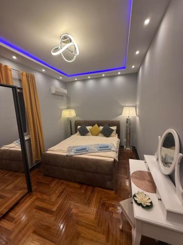 a bedroom with a bed and a blue ceiling at Luxusvilla im Herzen von Baden in Baden