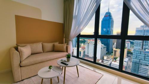 a living room with a couch and a large window at Majestic Residence KL in Kuala Lumpur