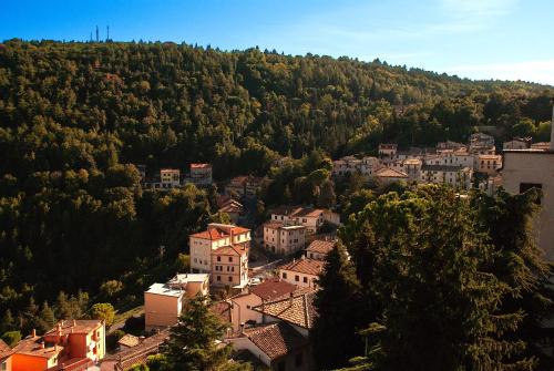 a view of a town on a hill with trees at Rocca Contrada in Arcevia