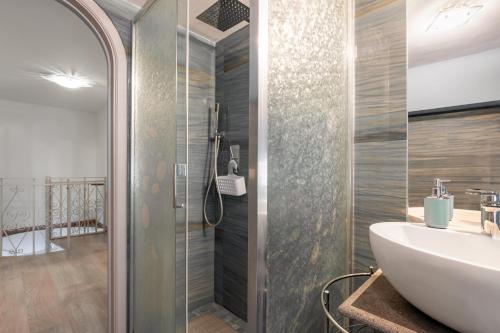 a bathroom with a sink and a shower at Domus Elisae - Taormina in Taormina