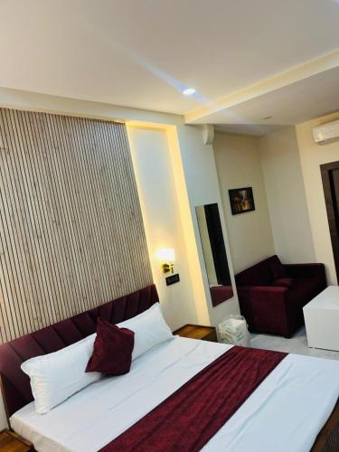 a hotel room with a bed and a couch at Hotel Manglam in Kota