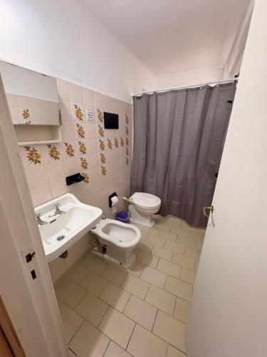 a bathroom with a toilet and a sink at Black Suites Pinamar in Pinamar