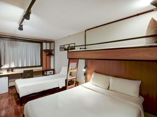 ein Schlafzimmer mit zwei Etagenbetten und einem Schreibtisch in der Unterkunft ibis Copacabana Posto 2 in Rio de Janeiro