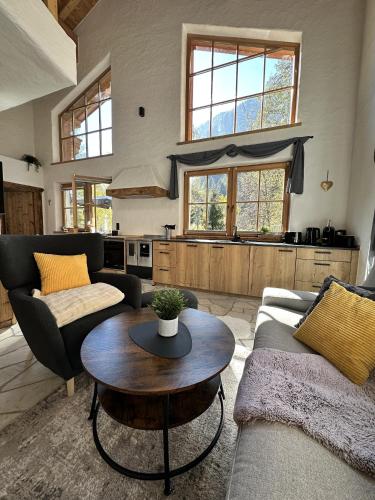 a living room with a couch and a table at Chalet am Bachl 1 in Flattach