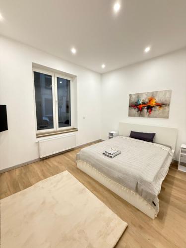 a white bedroom with a bed and a window at Exklusives City-Zimmer, Gemeinschaftsbad und Küche in Herne