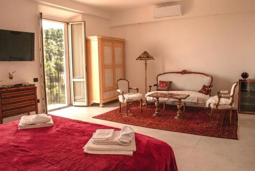 a living room with a red bed and a tv at Rocca Contrada in Arcevia