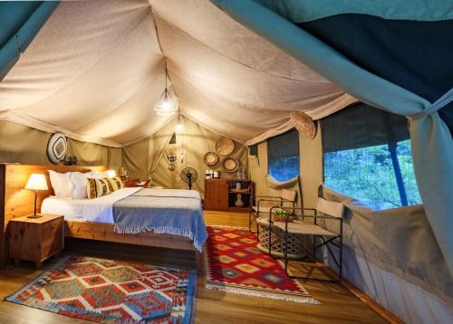 a bedroom with a bed in a tent at Pearl Mara in Masai Mara