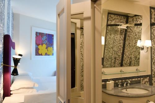 a bathroom with a sink and a mirror at Hotel Majestic in Lido di Jesolo