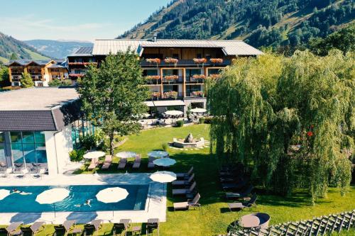 a hotel with a swimming pool and a resort at Rauriserhof 4 Sterne Superior in Rauris