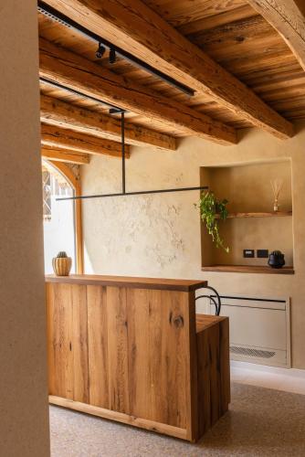 a kitchen with a wooden counter and a window at La Ghiandaia Farmhouse in Conegliano